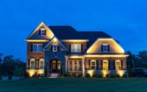 aqua-bright illuminated home in the evening with exterior landscape lighting installed